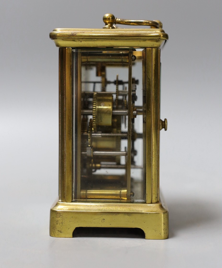 A brass carriage timepiece, retailed by J. Moser & co. in leather case with key.